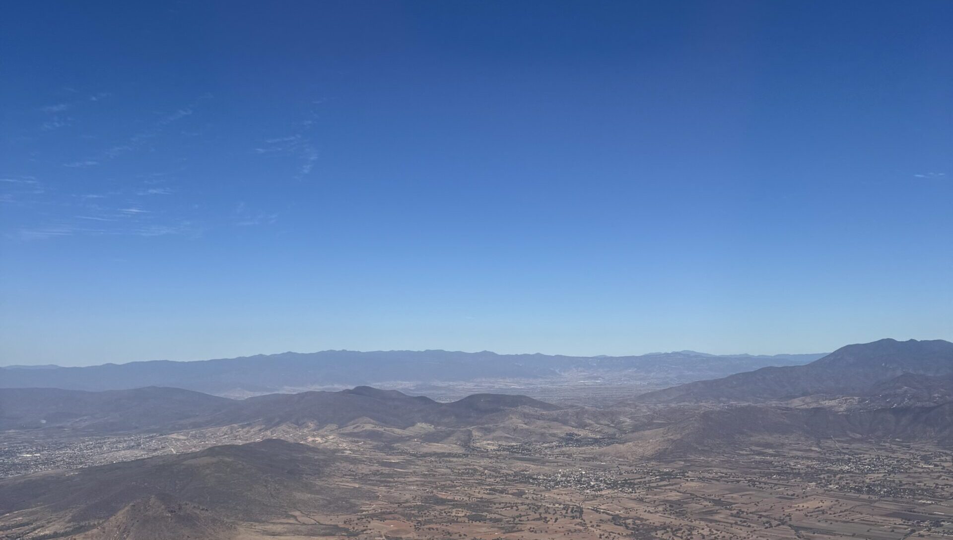 The view over Oaxaca from the plane, showing mountains and planes.
